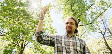 Will Yaeger ' 24 holding a small white mushroom.